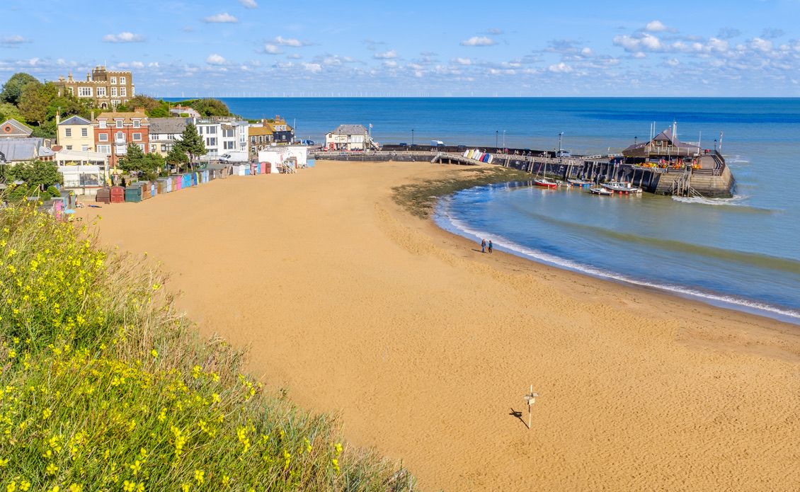 Golden sand of Viking Bay Broadstairs, Thanet, Kent, UK and the historic Bleak House on a sunny autumn day.