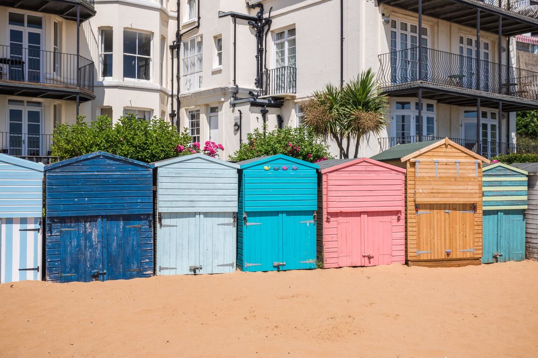 Colourful beach huts on the sandy beach of Viking Bay in the seaside town of Broadstairs, east Kent, England