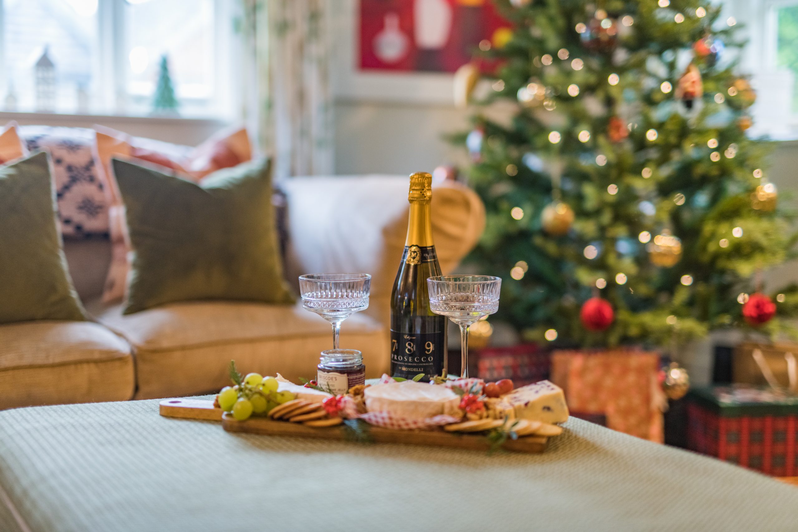 Cheese board and prosecco in front of the Christmas tree