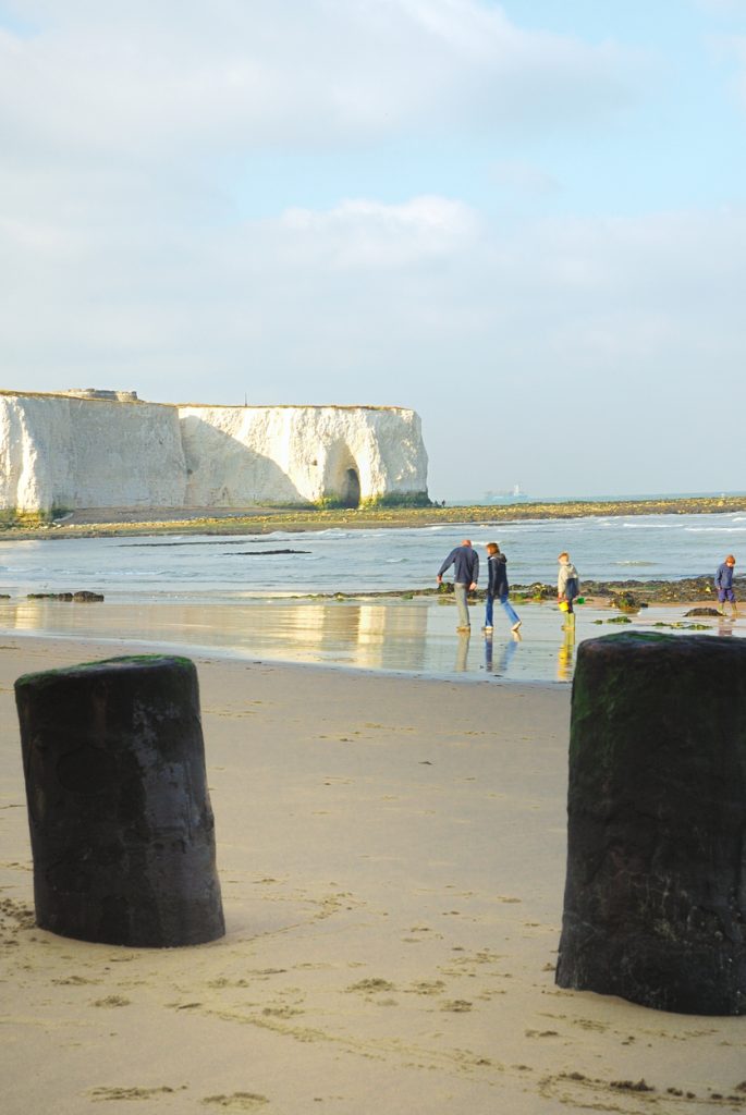 Family walking along the beach in Broadstairs, Kent