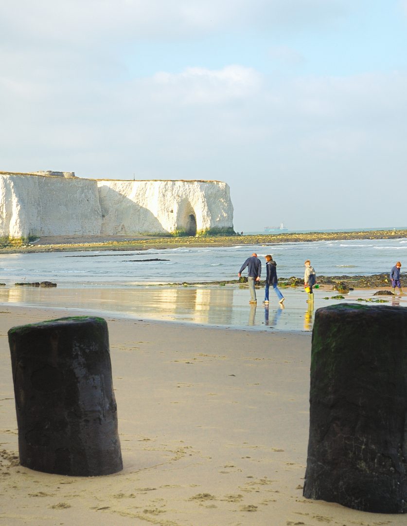 Family walking along the beach in Broadstairs, Kent