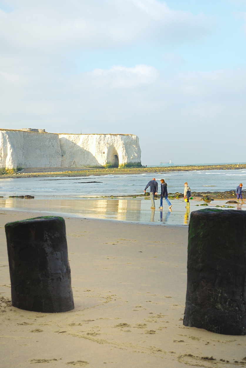 Family walking along the beach in Broadstairs, Kent