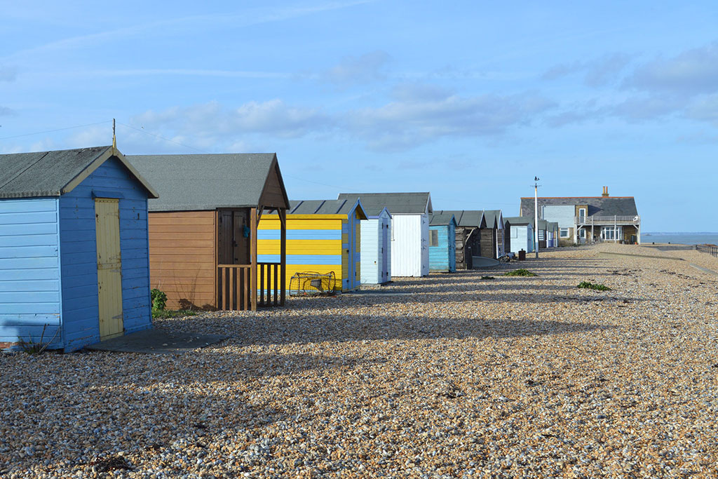 Row of colourful beach huts on Kingsdown Beach, Kent