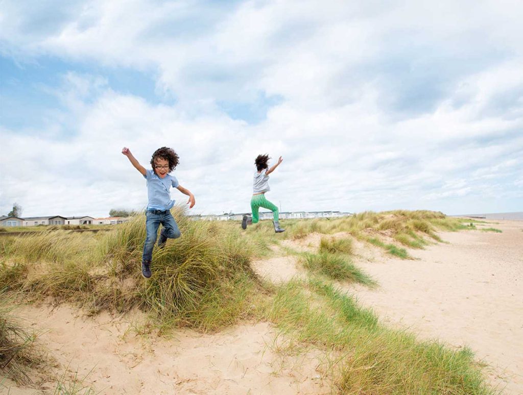 kids jumping on the beach