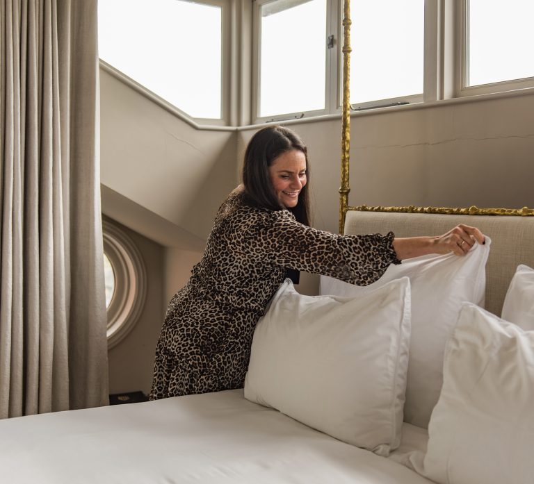 Sarah Setz, property manager at Keepers Cottages making a bed